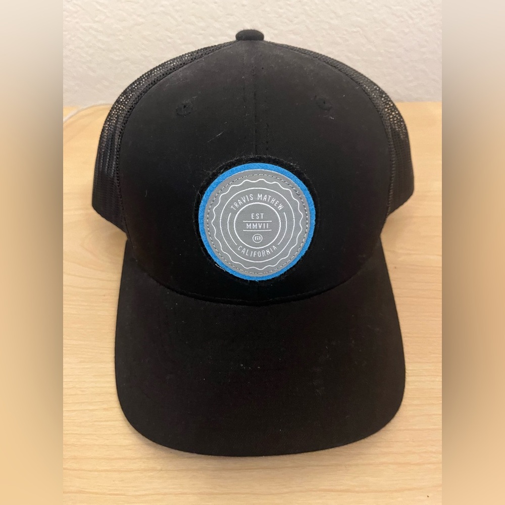 Travis Mathew Black Trucker Hat with Blue Patch